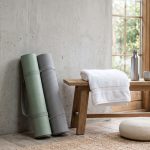 Minimalist gym corner with dumbbells and yoga mat — men's chest health guide, Gynecomastia LA